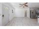 Sunlit living area featuring tile floors, connecting to the kitchen with stainless steel appliances at 1341 Sandy Ln, Clearwater, FL 33755