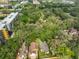 Stunning aerial view of a home nestled among lush greenery in a vibrant neighborhood at 13703 Sweetwater Cove Pl, Tampa, FL 33613