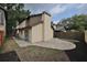 A beautiful view of the rear exterior with a beige stucco wall and a paved brick patio at 13703 Sweetwater Cove Pl, Tampa, FL 33613