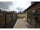 The backyard featuring brick paver patio, mulched landscaping, and sliding glass doors at 13703 Sweetwater Cove Pl, Tampa, FL 33613