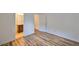 Light filled room featuring hardwood floors and a glimpse into an attached bathroom with vanity at 13703 Sweetwater Cove Pl, Tampa, FL 33613