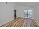 Bedroom featuring vinyl plank flooring and a large window overlooking the front yard at 13703 Sweetwater Cove Pl, Tampa, FL 33613