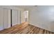 Bedroom featuring hard wood floors, closet with folding doors, and bright natural light at 13703 Sweetwater Cove Pl, Tampa, FL 33613
