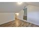 Cozy bedroom with wood-look flooring leading to other areas of the home, perfect for relaxation at 13703 Sweetwater Cove Pl, Tampa, FL 33613