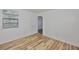 Bedroom with wood-look floors, complemented by a large window offering plenty of natural light at 13703 Sweetwater Cove Pl, Tampa, FL 33613