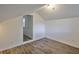 Bright bedroom with wood-look flooring and a doorway leading out, enhancing the flow of the home at 13703 Sweetwater Cove Pl, Tampa, FL 33613