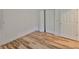 Bedroom features new wood floors, closet with bi-fold doors, and bright natural light at 13703 Sweetwater Cove Pl, Tampa, FL 33613