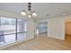 Bright dining area with views of the kitchen and backyard, complemented by a modern chandelier at 13703 Sweetwater Cove Pl, Tampa, FL 33613