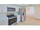 Modern kitchen featuring stainless steel appliances and white cabinets at 13703 Sweetwater Cove Pl, Tampa, FL 33613