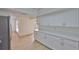 Kitchen featuring long countertops, stainless steel appliances, and white cabinets at 13703 Sweetwater Cove Pl, Tampa, FL 33613