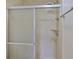 Close-up of tiled shower with glass door, including two shower heads and built-in corner shelves at 13703 Sweetwater Cove Pl, Tampa, FL 33613