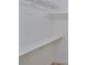 Bright walk-in closet featuring white walls, shelving, and hanging racks for optimal storage and organization at 13703 Sweetwater Cove Pl, Tampa, FL 33613