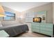 Bedroom showcases natural light, a dresser with a mirror and sleek flooring at 14710 Gulf Blvd # 101, Madeira Beach, FL 33708