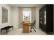 Well-lit home office with a stylish desk, comfortable chair, and a modern bookcase at 15027 Zircon Red Dr, Wimauma, FL 33598