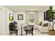 Comfortable living room with neutral tones, contemporary furnishings, and natural light from a nearby window at 15042 Zircon Red Dr, Wimauma, FL 33598