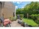 Peaceful backyard patio with a bench, potted plants, and green landscaping offering a relaxing outdoor retreat at 16504 Lake Brigadoon Cir, Tampa, FL 33618