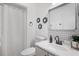 Stylish bathroom with a modern vanity, toilet, decorative wall art and a shower curtain at 16504 Lake Brigadoon Cir, Tampa, FL 33618