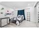 Bright bedroom with minimalist decor, curtains, a bed, a sleek desk, and ample closet space at 16504 Lake Brigadoon Cir, Tampa, FL 33618