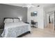 Bedroom with a bed, desk, and TV offering a functional and modern living space at 16504 Lake Brigadoon Cir, Tampa, FL 33618