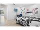 A stylish bedroom featuring a TV, desk, bed, and minimalistic decor, all contributing to a relaxing atmosphere at 16504 Lake Brigadoon Cir, Tampa, FL 33618
