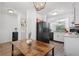 Cozy eat-in kitchen featuring white cabinets, black appliances, and space for a dining table at 16504 Lake Brigadoon Cir, Tampa, FL 33618
