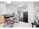 Bright kitchen featuring white cabinets, modern appliances, and an eat-in dining area at 16504 Lake Brigadoon Cir, Tampa, FL 33618