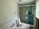 Bathroom needing renovation featuring a toilet and glass-enclosed shower at 1910 New Hampshire Ne Ave, St Petersburg, FL 33703