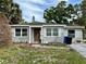 Charming single-story home with neutral tones, complemented by well-maintained landscaping at 1910 New Hampshire Ne Ave, St Petersburg, FL 33703