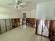 Room showing ceiling fan and open floor plan needing renovation at 1910 New Hampshire Ne Ave, St Petersburg, FL 33703