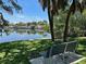 Park bench overlooking serene water views, surrounded by lush greenery and palm trees at 1910 New Hampshire Ne Ave, St Petersburg, FL 33703