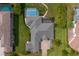 Bird's-eye view of a luxury home with a large screened pool and paver driveway at 19815 Sea Rider Way, Lutz, FL 33559