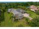 Aerial view of home with lush landscaping and backyard, including a screened-in pool and an inviting outdoor space at 19815 Sea Rider Way, Lutz, FL 33559