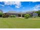 Beautiful backyard featuring lush landscaping, mature trees, a screened porch, and a winding brick path to the house at 19815 Sea Rider Way, Lutz, FL 33559