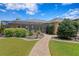 Expansive backyard featuring lush landscaping, a screened-in porch, and a winding brick path to the house at 19815 Sea Rider Way, Lutz, FL 33559