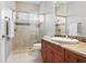 Modern bathroom featuring a glass enclosed shower and a vanity with a granite countertop at 19815 Sea Rider Way, Lutz, FL 33559