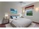 Bright bedroom with a large window, a ceiling fan, and decoratively matching bedside lamps and nightstands at 19815 Sea Rider Way, Lutz, FL 33559