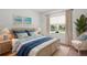 Bright bedroom featuring tropical decor, a comfortable bed, and natural light at 19815 Sea Rider Way, Lutz, FL 33559