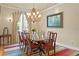 Charming dining room features a classic chandelier and space for an eight person dining set at 19815 Sea Rider Way, Lutz, FL 33559