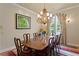 Open dining room area features a classic chandelier and space for an eight person dining set at 19815 Sea Rider Way, Lutz, FL 33559