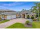 Beautiful single-story home showcasing a well-manicured front yard and brick-paved driveway with a three-car garage at 19815 Sea Rider Way, Lutz, FL 33559