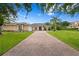 Beautiful exterior elevation showcasing a brick driveway, manicured lawn, and inviting facade at 19815 Sea Rider Way, Lutz, FL 33559