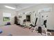 Brightly lit home gym with multiple windows and exercise equipment at 19815 Sea Rider Way, Lutz, FL 33559