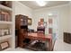 Cozy home office featuring a wooden desk, plush chair, and built-in shelving at 19815 Sea Rider Way, Lutz, FL 33559