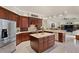Open kitchen with stainless steel appliances, center island, and seamless flow to the living area at 19815 Sea Rider Way, Lutz, FL 33559