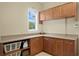 Well-organized laundry room with ample cabinet space, a window, and a countertop at 19815 Sea Rider Way, Lutz, FL 33559