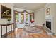 Spacious living room featuring hardwood flooring, fireplace, and french doors to the lanai at 19815 Sea Rider Way, Lutz, FL 33559
