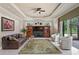 Well-lit living room with a large media center and built-in shelving, overlooking the lanai at 19815 Sea Rider Way, Lutz, FL 33559