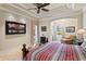 Comfortable main bedroom featuring a tray ceiling, tile floors, and decorative art at 19815 Sea Rider Way, Lutz, FL 33559