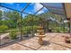 Spacious screened-in patio with beautiful fountain and lush landscaping at 19815 Sea Rider Way, Lutz, FL 33559