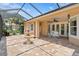 Spacious screened-in patio with a fountain, overhead fan, and plenty of space at 19815 Sea Rider Way, Lutz, FL 33559